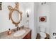 Elegant powder room with granite countertop, ornate mirror, and stylish fixtures at 235 The Prado N, Atlanta, GA 30309