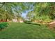 Expansive backyard featuring lush green lawn and mature trees, offering a private and serene outdoor space at 235 The Prado N, Atlanta, GA 30309
