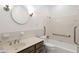Neutral bathroom featuring a vanity sink, toilet, shower/tub combination, and accessibility handrails at 235 The Prado N, Atlanta, GA 30309