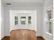 Dining room boasting hardwood floors, white trim, and a bay window offering scenic outdoor views at 235 The Prado N, Atlanta, GA 30309