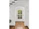Bright and airy entryway features hardwood floors, decorative trim and an arched doorway with glass panes at 235 The Prado N, Atlanta, GA 30309