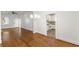 Open concept living and kitchen area with gleaming hardwood floors and white walls at 235 The Prado N, Atlanta, GA 30309