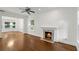 Bright living room with hardwood floors, a fireplace, and ample natural light from large windows at 235 The Prado N, Atlanta, GA 30309