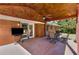 Back patio with brick flooring, ceiling fan, outdoor dining area and access to the home at 3113 Octavia Pl, Atlanta, GA 30340