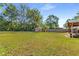 Lush green backyard features a covered patio, mature trees, and a charming shed at 3113 Octavia Pl, Atlanta, GA 30340