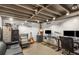 Finished basement with an open ceiling, two workstations, and a cozy seating area at 3113 Octavia Pl, Atlanta, GA 30340