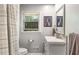 Cozy bathroom features a modern vanity, neutral color palette, and a window offering natural light at 3113 Octavia Pl, Atlanta, GA 30340