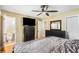 Cozy bedroom with wood floors, ceiling fan, and a view into an ensuite bathroom at 3113 Octavia Pl, Atlanta, GA 30340