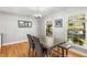 Bright dining room with wood floors, modern lighting, and large windows offering pleasant outdoor views at 3113 Octavia Pl, Atlanta, GA 30340