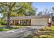 Inviting single-story home with a two-car garage, attractive shutters, and a well-maintained front yard at 3113 Octavia Pl, Atlanta, GA 30340