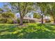 Beautifully landscaped front yard with mature trees surrounding an attractive single-story home with shutters at 3113 Octavia Pl, Atlanta, GA 30340