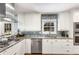 Updated kitchen with stainless steel appliances, granite countertops, mosaic backsplash, and abundant natural light at 3113 Octavia Pl, Atlanta, GA 30340