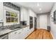 Modern kitchen with stainless appliances, granite countertops, stylish backsplash, and hardwood floors at 3113 Octavia Pl, Atlanta, GA 30340