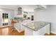 Well-lit kitchen boasting white cabinets, granite countertops, stainless appliances, and access to the outdoor space at 3113 Octavia Pl, Atlanta, GA 30340