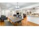 Open-concept living space with hardwood floors connecting the dining, kitchen, and living areas for easy entertaining at 3113 Octavia Pl, Atlanta, GA 30340