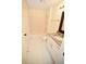 Standard bathroom with a shower-tub combo, granite countertops, and white tiled floors at 1075 Peachtree Ne Walk # A519, Atlanta, GA 30309