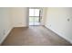 A basic bedroom with carpeted floors that leads to a sunny outdoor patio at 1075 Peachtree Ne Walk # A519, Atlanta, GA 30309