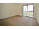 A neutral bedroom with carpeted floors and a sliding glass door to a balcony at 1075 Peachtree Ne Walk # A519, Atlanta, GA 30309