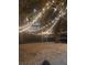 Inviting common area with string lights, trees, and the downtown skyline in the background at 1075 Peachtree Ne Walk # A519, Atlanta, GA 30309
