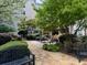 Landscaped courtyard featuring trees and seating areas with flowering bushes at 1075 Peachtree Ne Walk # A519, Atlanta, GA 30309