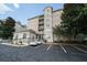 Apartment building featuring attractive landscaping, parking, and well-maintained grounds at 1075 Peachtree Ne Walk # A519, Atlanta, GA 30309