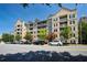 Exterior view of a modern condo building with balconies, manicured landscaping, and street parking at 1075 Peachtree Ne Walk # A519, Atlanta, GA 30309