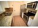 A kitchen with stainless steel appliances, brown tile backsplash, and granite countertops at 1075 Peachtree Ne Walk # A519, Atlanta, GA 30309