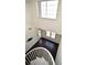 Top-down view of spiral staircase with dark floors and bright natural light at 1075 Peachtree Ne Walk # A519, Atlanta, GA 30309