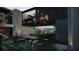 Contemporary home design showcases an outdoor patio area with comfortable seating, a reflecting pool and a garden at 2413 Spalding Dr, Atlanta, GA 30350