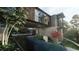 Stunning modern home with a unique architectural design and a tranquil reflecting pool surrounded by lush greenery at 2413 Spalding Dr, Atlanta, GA 30350