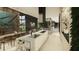 Open-concept kitchen with sleek countertops, modern appliances, and an adjacent dining area with stylish lighting fixtures at 2413 Spalding Dr, Atlanta, GA 30350