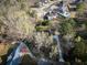 Aerial view of a property showcasing lush greenery, a long driveway, and surrounding neighborhood at 2923 Glenhaven Sw Ct, Conyers, GA 30094