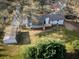 Aerial view of backyard featuring a wooden deck and a storage shed surrounded by trees at 2923 Glenhaven Sw Ct, Conyers, GA 30094