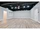 Finished basement with open ceiling, wood-look flooring, and neutral colors at 2923 Glenhaven Sw Ct, Conyers, GA 30094