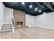Finished basement with wood-look flooring and brick fireplace at 2923 Glenhaven Sw Ct, Conyers, GA 30094