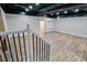 Finished basement with wood-look flooring, exposed ceiling, and brick fireplace at 2923 Glenhaven Sw Ct, Conyers, GA 30094