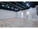 Spacious finished basement with wood-look flooring, neutral walls, and exposed ceiling at 2923 Glenhaven Sw Ct, Conyers, GA 30094
