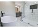Modern bathroom featuring a soaking tub and tiled walk-in shower at 2923 Glenhaven Sw Ct, Conyers, GA 30094
