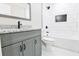 Bathroom featuring a gray vanity with granite countertop and a tiled shower/bathtub at 2923 Glenhaven Sw Ct, Conyers, GA 30094