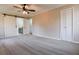 Bedroom with carpet, ceiling fan, closet, and sliding barn doors to bathroom at 2923 Glenhaven Sw Ct, Conyers, GA 30094