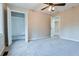 Bedroom featuring carpet flooring, a ceiling fan, closet, and a secondary door at 2923 Glenhaven Sw Ct, Conyers, GA 30094