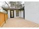 View of the wooden deck next to the house with an entry door and painted brick at 2923 Glenhaven Sw Ct, Conyers, GA 30094