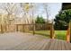 Spacious wooden deck with natural wood railings overlooking a well-maintained lawn and wooded area at 2923 Glenhaven Sw Ct, Conyers, GA 30094