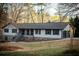 Beautiful home with white siding, dark shutters, stone foundation, and attached garage with a well-maintained lawn at 2923 Glenhaven Sw Ct, Conyers, GA 30094