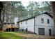 Back view of the house featuring a back porch, white painted brick, and a grey exterior at 2923 Glenhaven Sw Ct, Conyers, GA 30094