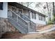 Home exterior featuring a stone foundation, manicured steps, and decorative wrought iron railings at 2923 Glenhaven Sw Ct, Conyers, GA 30094