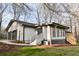 Home exterior showcasing an attached garage, back entrance, and new landscaping at 2923 Glenhaven Sw Ct, Conyers, GA 30094