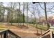 View of the front yard featuring mature trees and landscaping at 2923 Glenhaven Sw Ct, Conyers, GA 30094