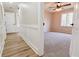 Hallway leading to a bedroom featuring wood-look flooring and wainscoting at 2923 Glenhaven Sw Ct, Conyers, GA 30094