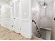 Hallway with wood-look floors, wainscoting and a staircase leading to the basement at 2923 Glenhaven Sw Ct, Conyers, GA 30094